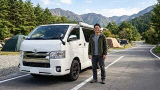 Toyota Hiace with Modern Stylish Mudguards Parked at Campsite with Owner